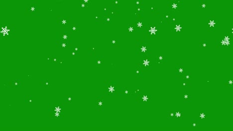 caída en forma de copos de nieve en un fondo verde. navidad movimiento gráfico de vídeo de animación. papel de pared clave de croma