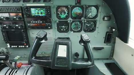 Cessna aircraft cockpit interior steering controls moving during flight with instrument display
