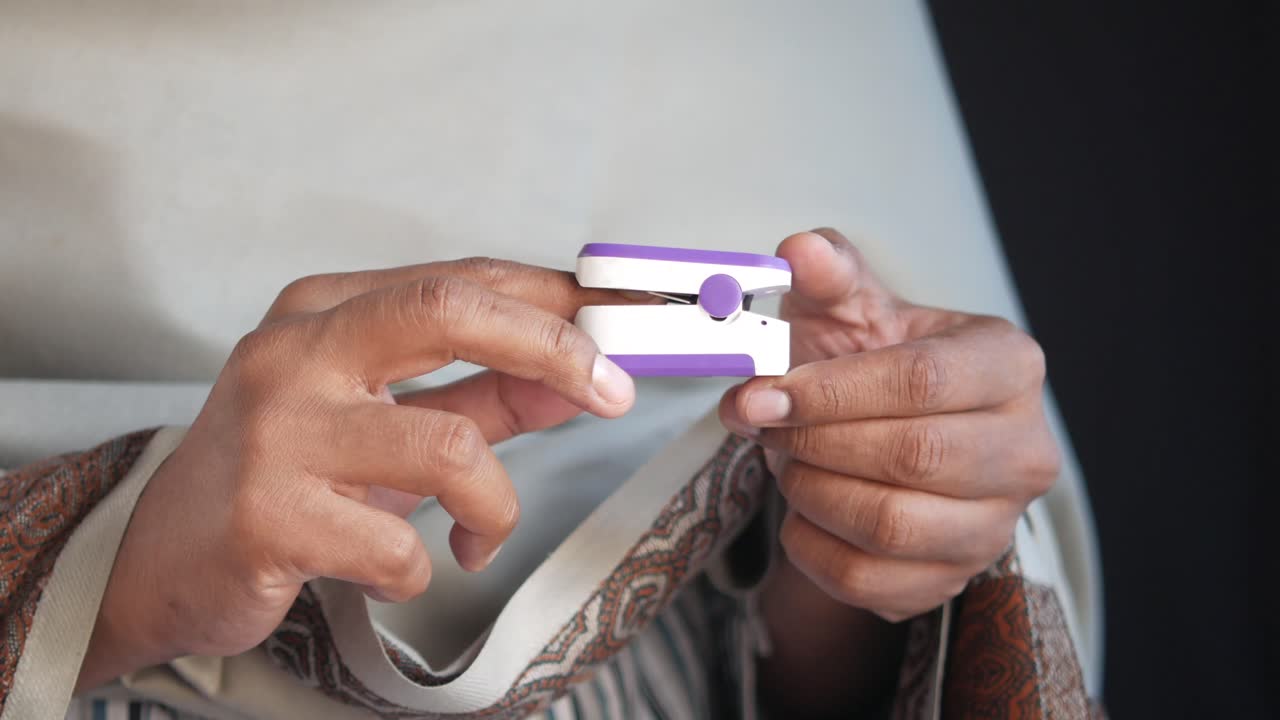 Person using a pulse oximeter