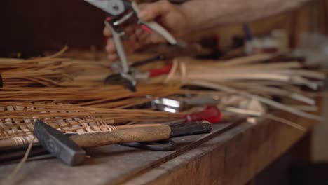 Old-man-picking-tool-to-work-wicker