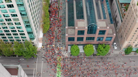 overhead drone view of the cancel canada day march as native people protest against discrimination in vancouver bc canada, top down aerial shot moving forward in uhd