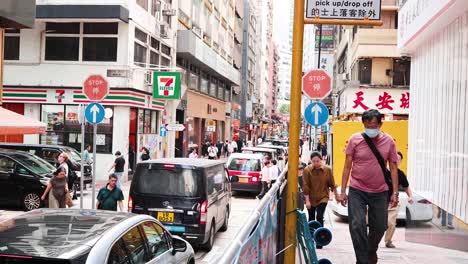 pedestrians navigate a busy urban street