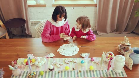 mother and daughter making easter cookies