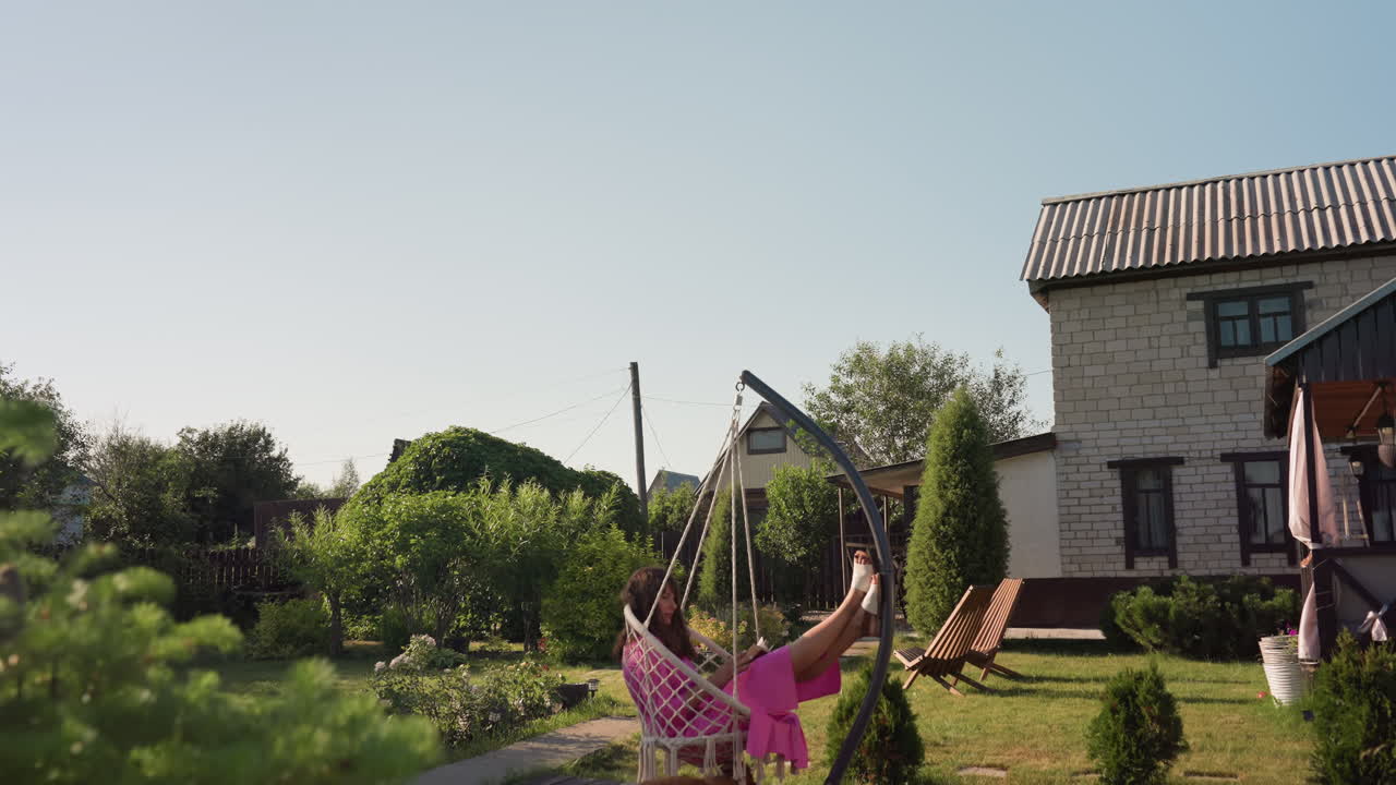 Woman On Swing, Serene Lady On Hanging Outdoor Swing, Calm Woman Enjoying Peaceful Summer In Garden Swing, Tranquil Lady Resting On Hanging Swing Amidst Lush Garden Scenery And Sunlight