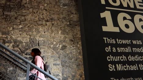 woman climbing stairs to reach st michael's tower viewpoint at dublinia museum