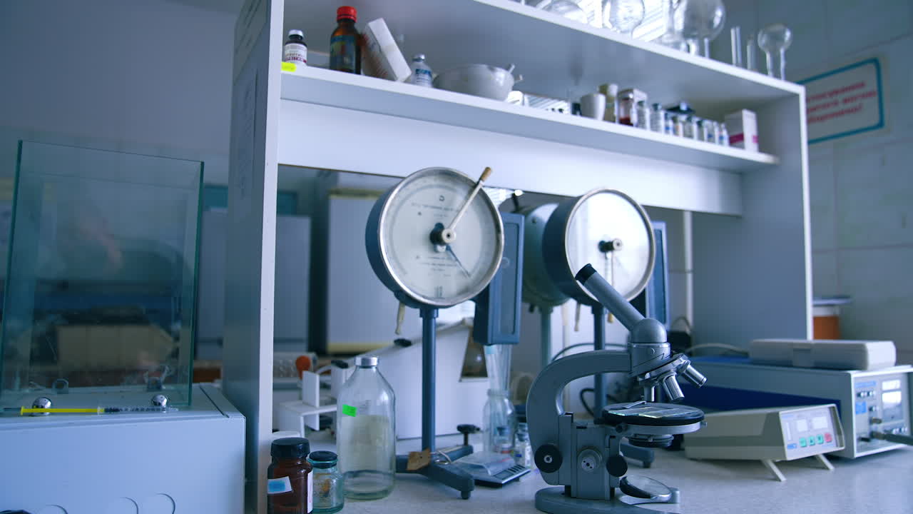 Medical laboratory interior with no people in. Microscope, scales, bottles and beakers in the lab.