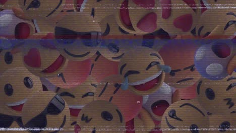 Digital-animation-of-multiple-face-emojis-falling-against-tv-static-effect