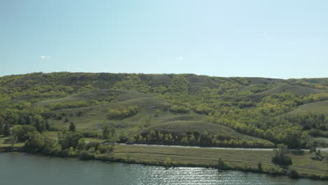 Scenic-View-Of-A-Car-Driving-Along-Buffalo-Pound-Lakeshore-In-Saskatchewan-Provincial-Park,-Canada