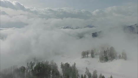 an aerial shot of a clear white snowscape on a mountain on a slightly cloudy weather in austria austria