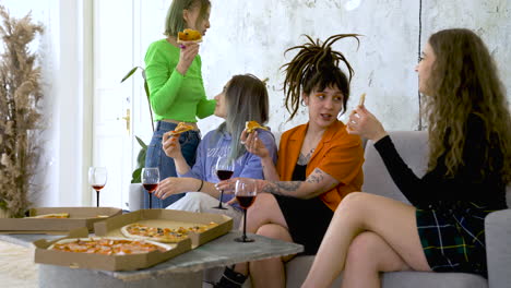 happy female friends eating pizza and drinking wine at home 1