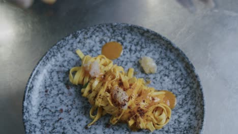 A-professional-chef-in-Italy-is-prepairing-a-plate-of-pasta-and-scampi-in-his-kitchen---02