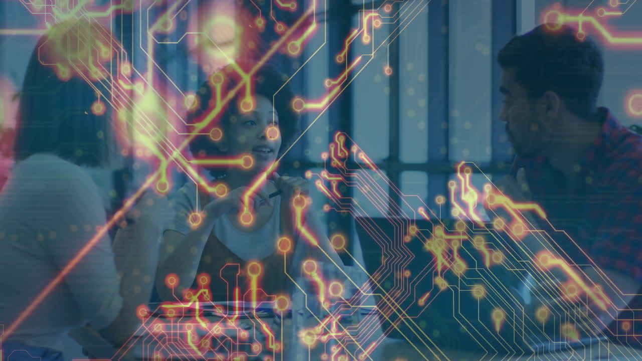 Discussing animation, diverse colleagues at table with digital network connections