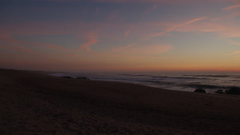 romantic colors after sunset on sandy coast, handheld view