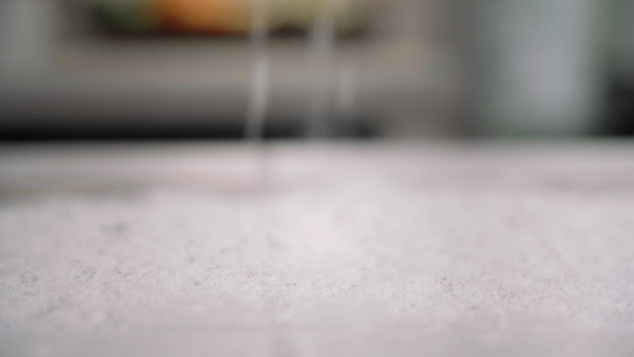 Sprinkling flour onto a counter top
