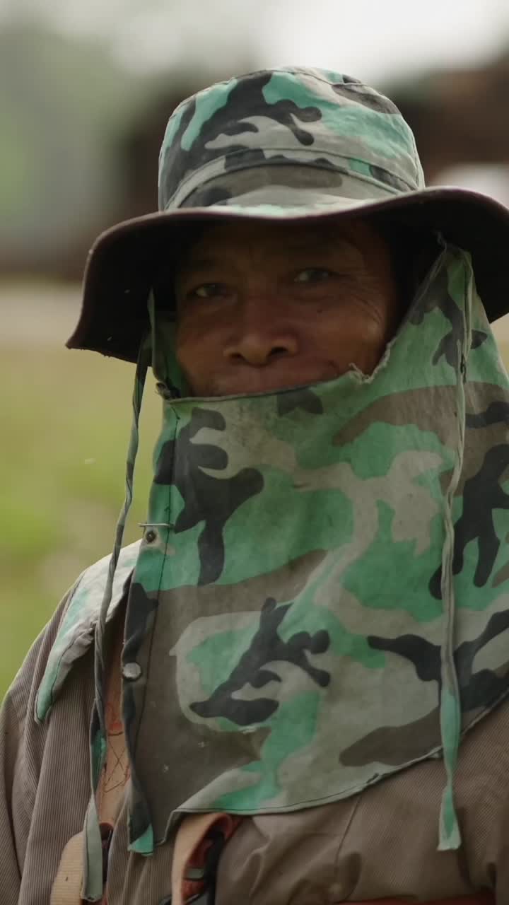 Man in camouflage hat and bandana