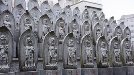 many buddhist statues standing at small shrine in kyoto japan 4k