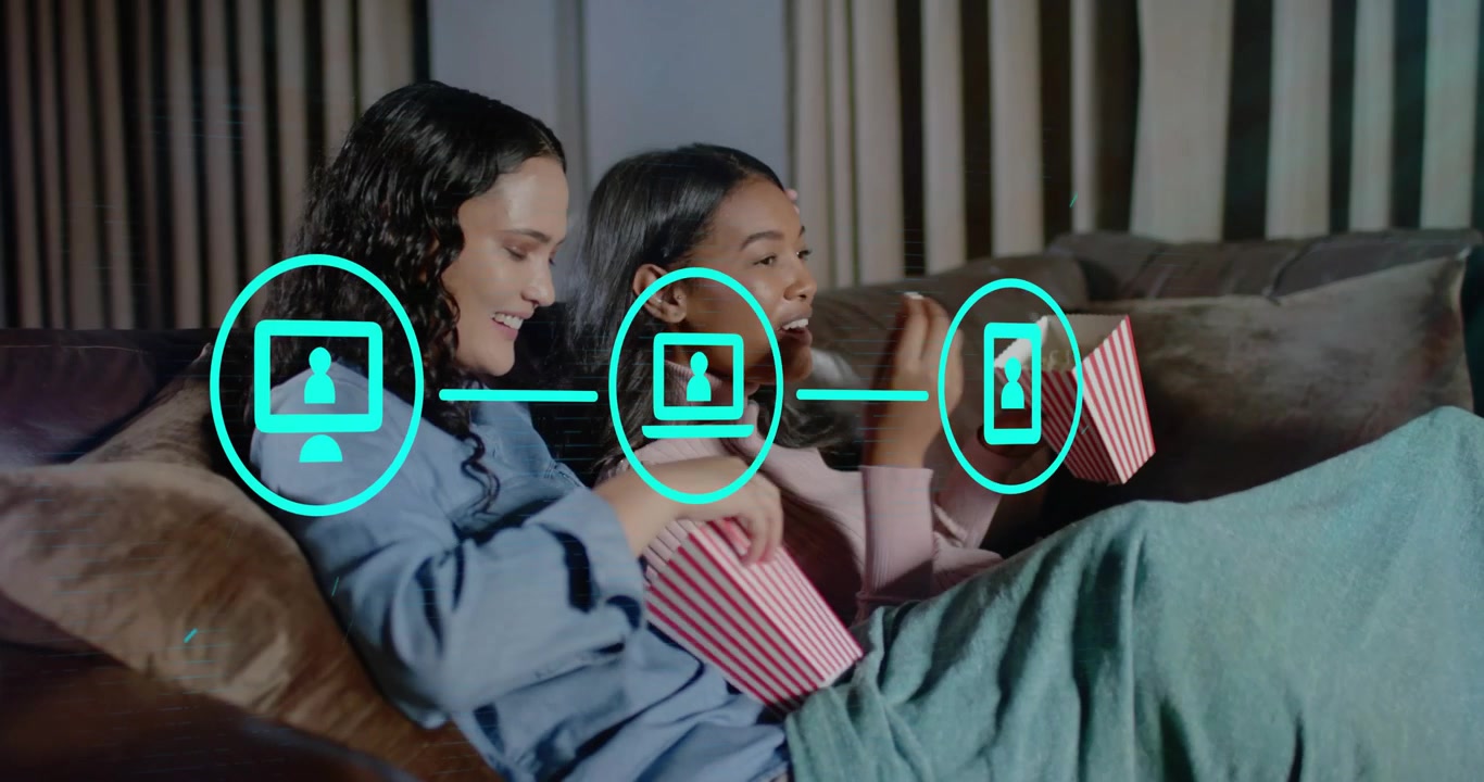 Friends snacking popcorn as teal icons popping up and linking screens, exploring tech connectivity