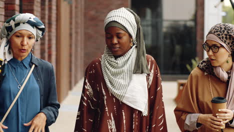 female friends walking by building