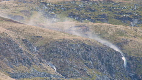 Waterfall-inverted-by-strong-winds-with-spray-being-blown-onto-the-hillside-above,-in-the-mallerstang-valley-Cumbria-UK