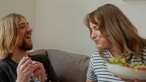 sweet and funny couple playfully fighting over grapes. slow motion shot