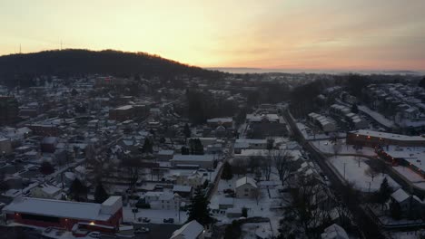 Rising-aerial-features-sunrise,-sunset-at-ski-town-in-USA