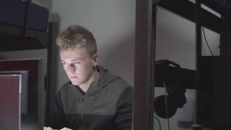 A left to right pan of a person typing on a computer