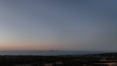 drone shot towards mountains at sunset