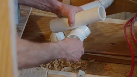 plumbers hands cleaning pvc pipe before installation