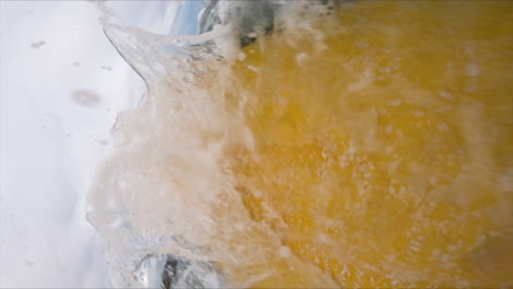 a male model is surfing with a yellow longboard in mui ne bay, vietnam