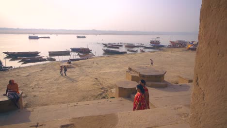 indian women walking along the ganges