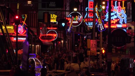 establishing night and crowds on beale street memphis tennessee with neon signs bars and clubs 1