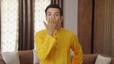 indian man giving flying kisses to the camera