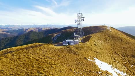 Cinematic-Aerial-shot-of-Communication-tower-a-top-Mount-Grey,-New-Zealand