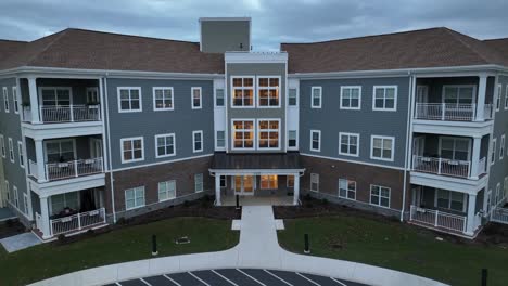 aerial rising shot of retirement home assisted living building at dusk