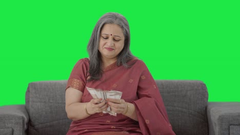 Happy-Indian-old-woman-counting-money-Green-screen