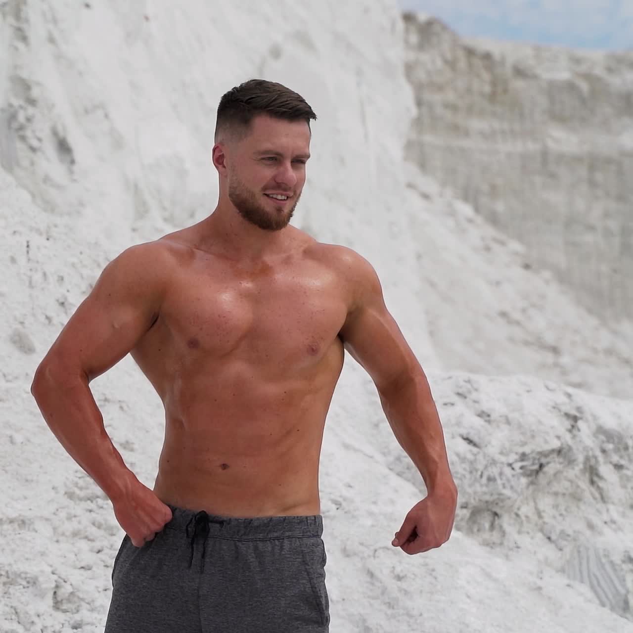 Athletic man standing with naked torso