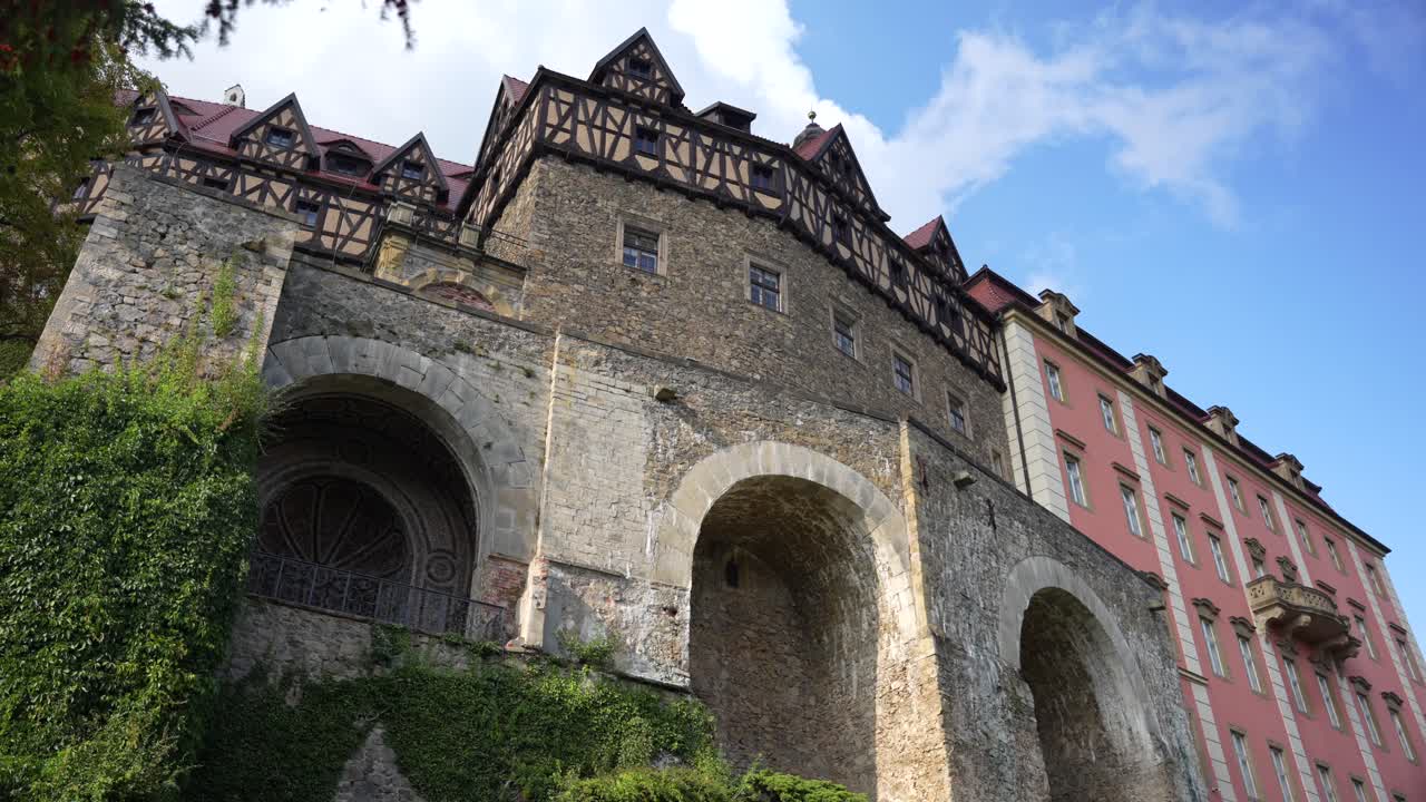 Historic palace in Poland, Ksiaz Castle, with old stone arches and pink facade