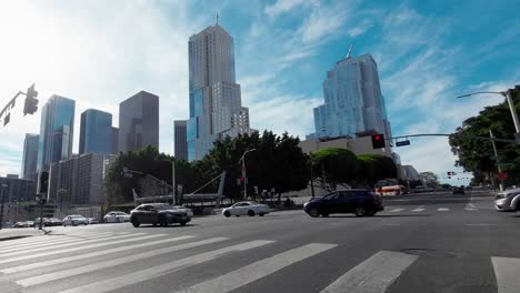 el horizonte de la ciudad de los ángeles en un día brillante con nubes tenues en el cielo, como se ve desde una intersección del centro