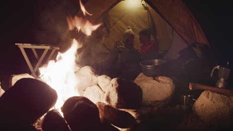 caucasian couple camping in nature by night