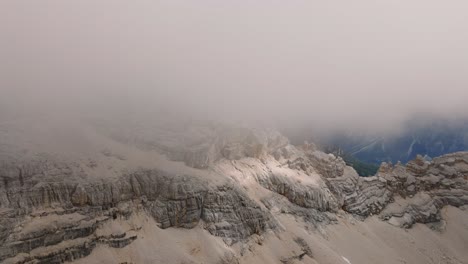 aerial forward view of monte pelmo in its peak in mist and clouds