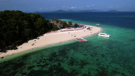 fixed drone shot of tourist boats moored at the ko khai nok island, in thailand