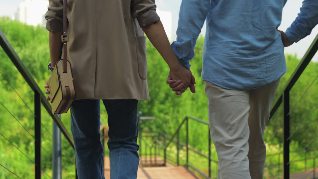 Couple Walking Hand in Hand in Nature