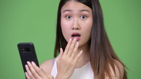 young beautiful asian businesswoman using phone