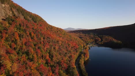 Beautiful-aerial-drone-footage-of-the-fall-leaves-on-and-around-Mount-Hor,-Mount-Pisgah,-and-Lake-Willoughby-during-peak-autumn-foliage-at-Willoughby-State-forest-in-Westmore,-Vermont