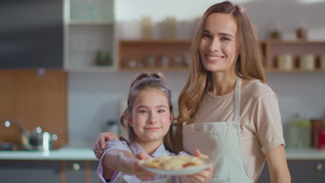 mother and daughter baking cookies