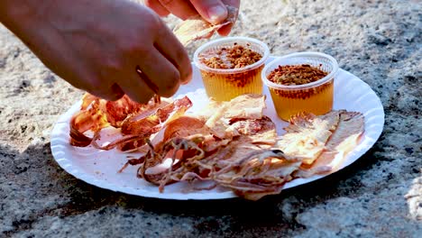 eating dried squid with dipping sauce