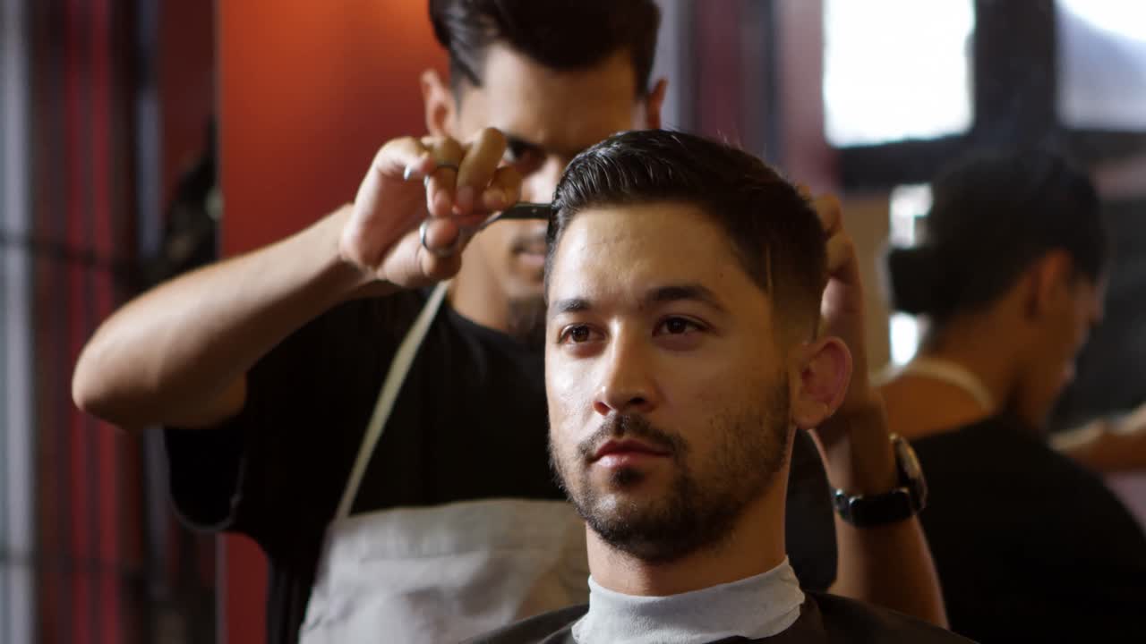 barbero recortando el cabello de los clientes en la barbería 4k
