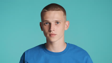 Young-man-in-blue-T-Shirt-asking-for-silence