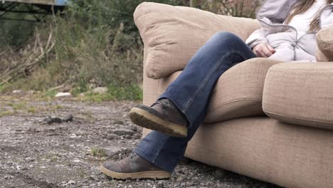 Woman-relaxing-on-sofa-in-outside-yard-medium-shot