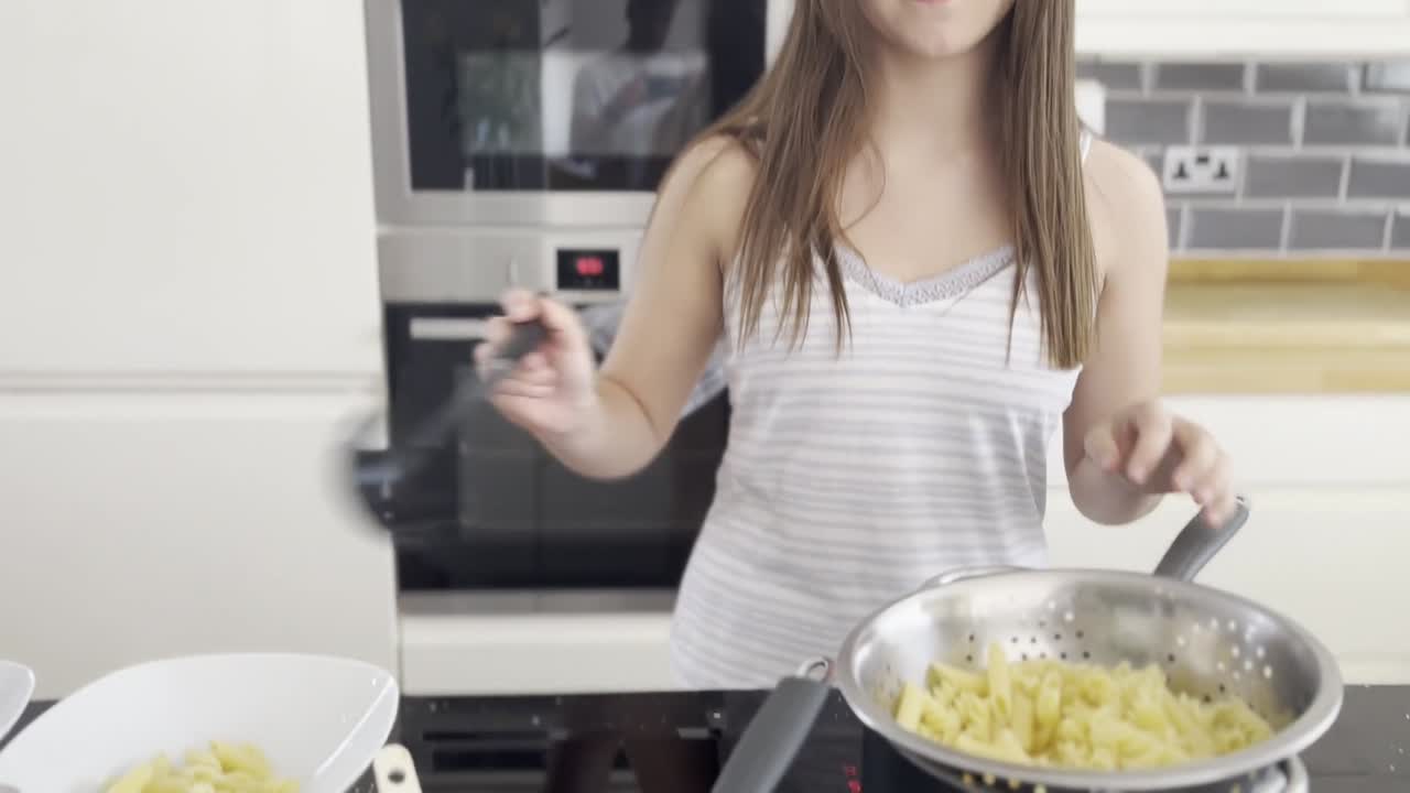 Premium Stock Video Young Female Making Pasta And Sauce In A Large Kitchen Late At Night 